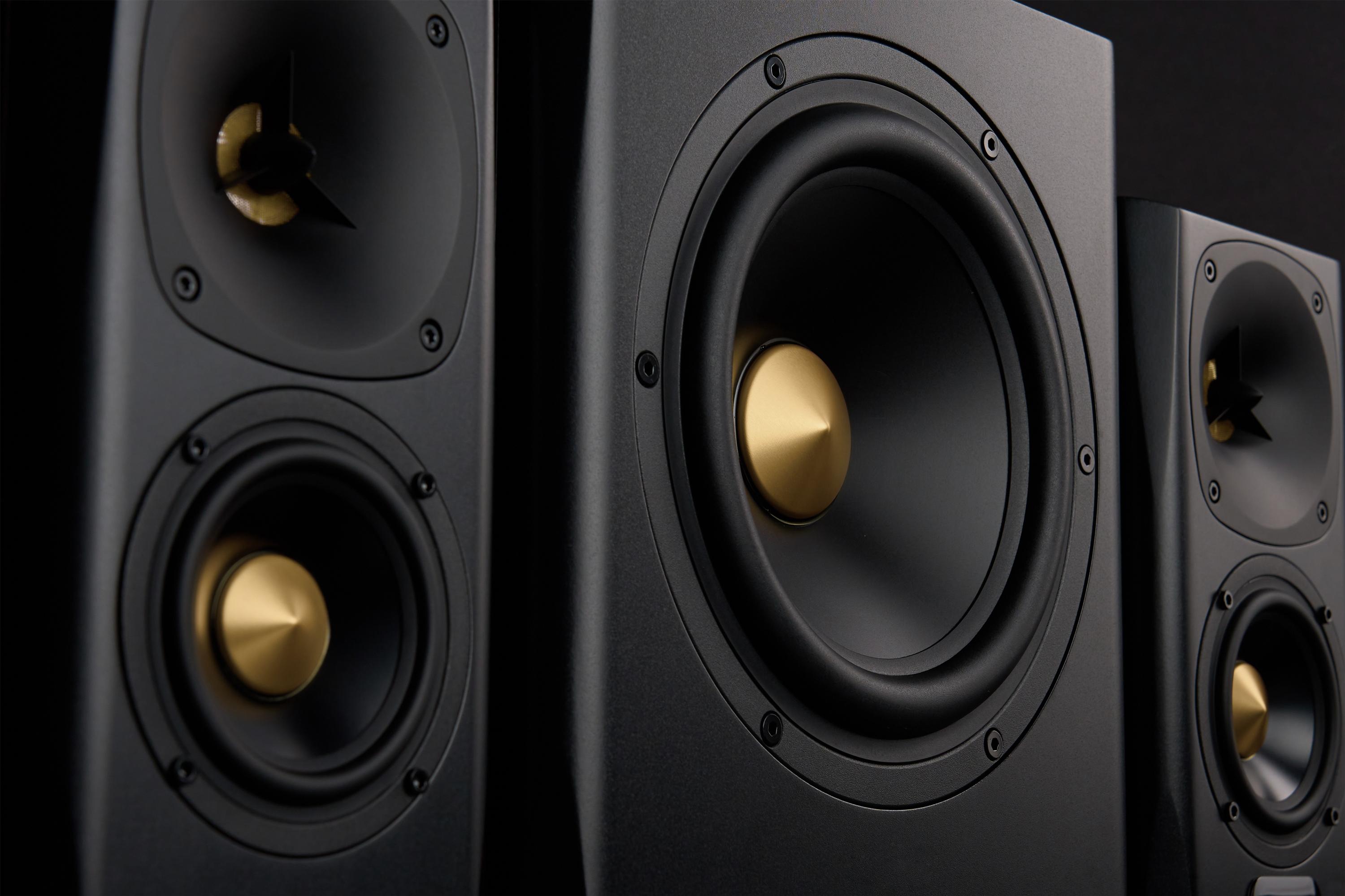 Close-up view of premium black and gold speakers. 