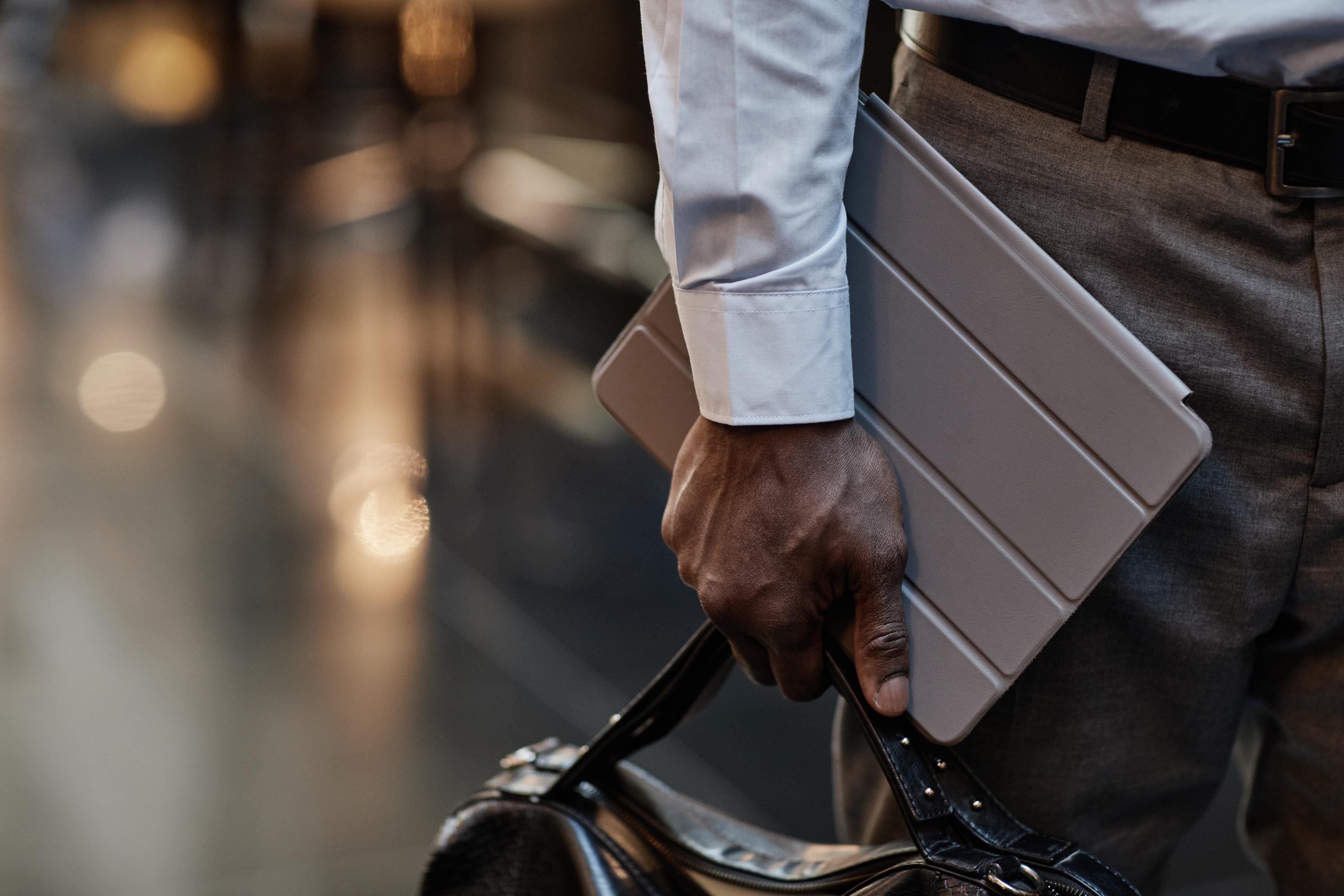 Close up shot of a man's hand holding a device