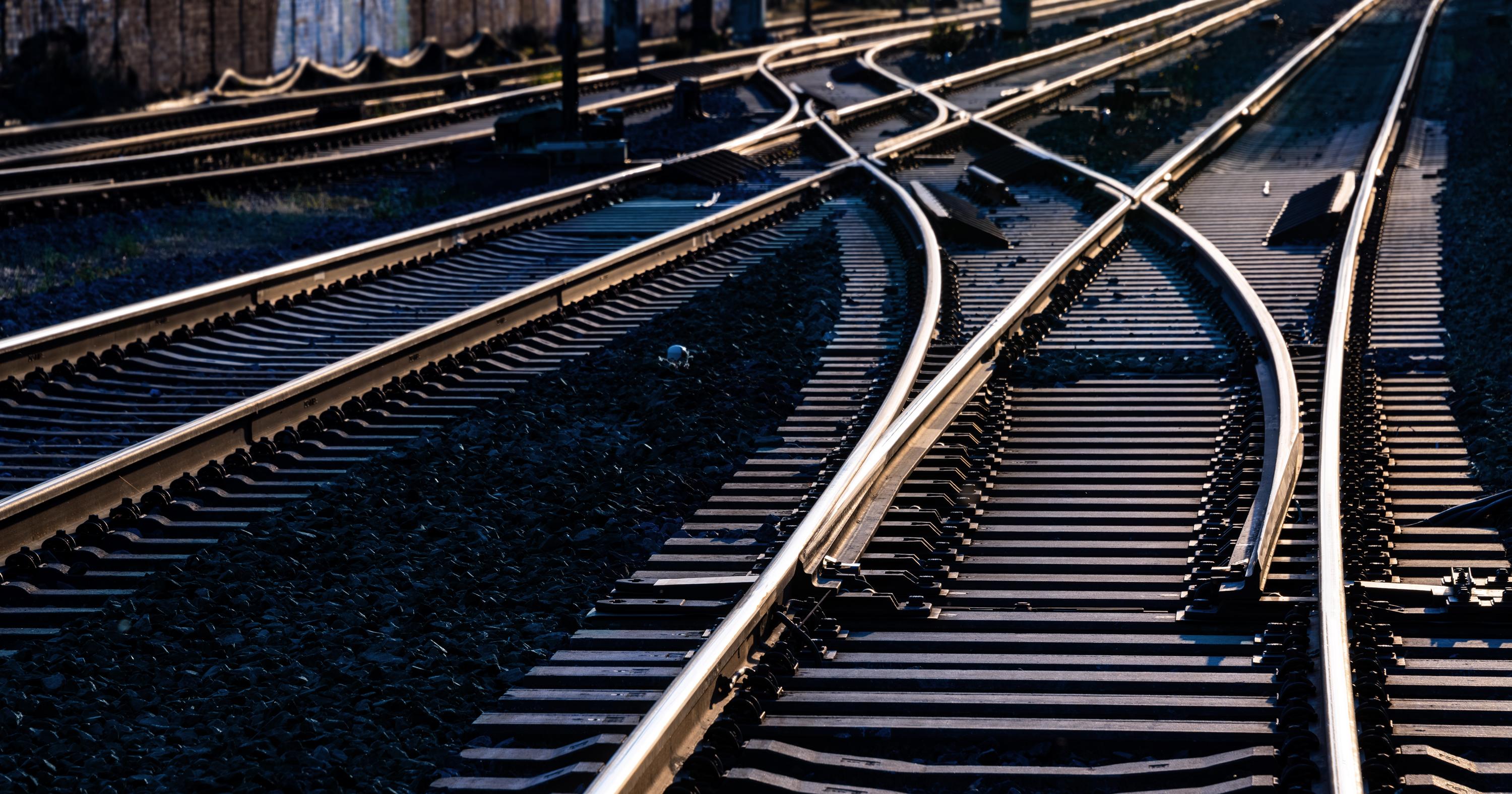 A set of railway tracks converging and diverging, illustrating transportation infrastructure. 